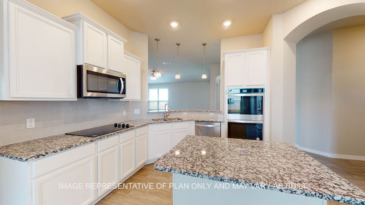 Sierra kitchen with white cabinets and built-in double oven.