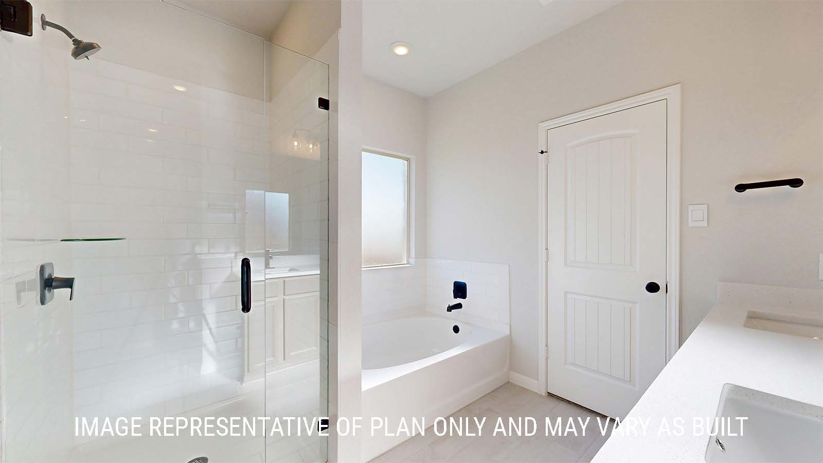 Parker II primary bathroom with walk-in shower and garden tub with window.