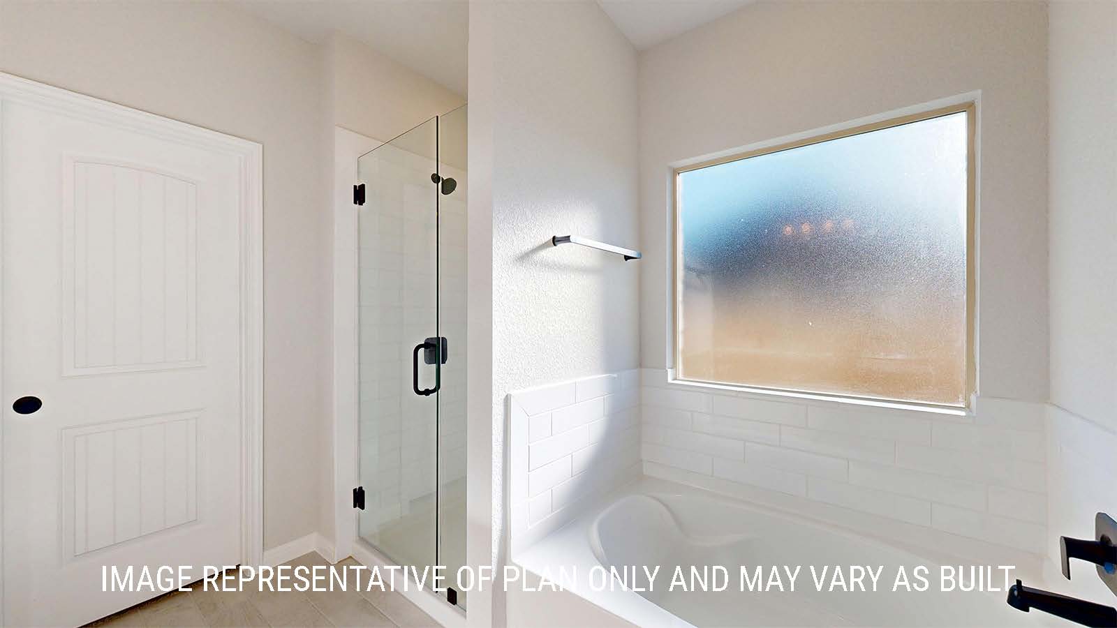 Parker II primary bathroom with walk-in shower and garden tub with window.