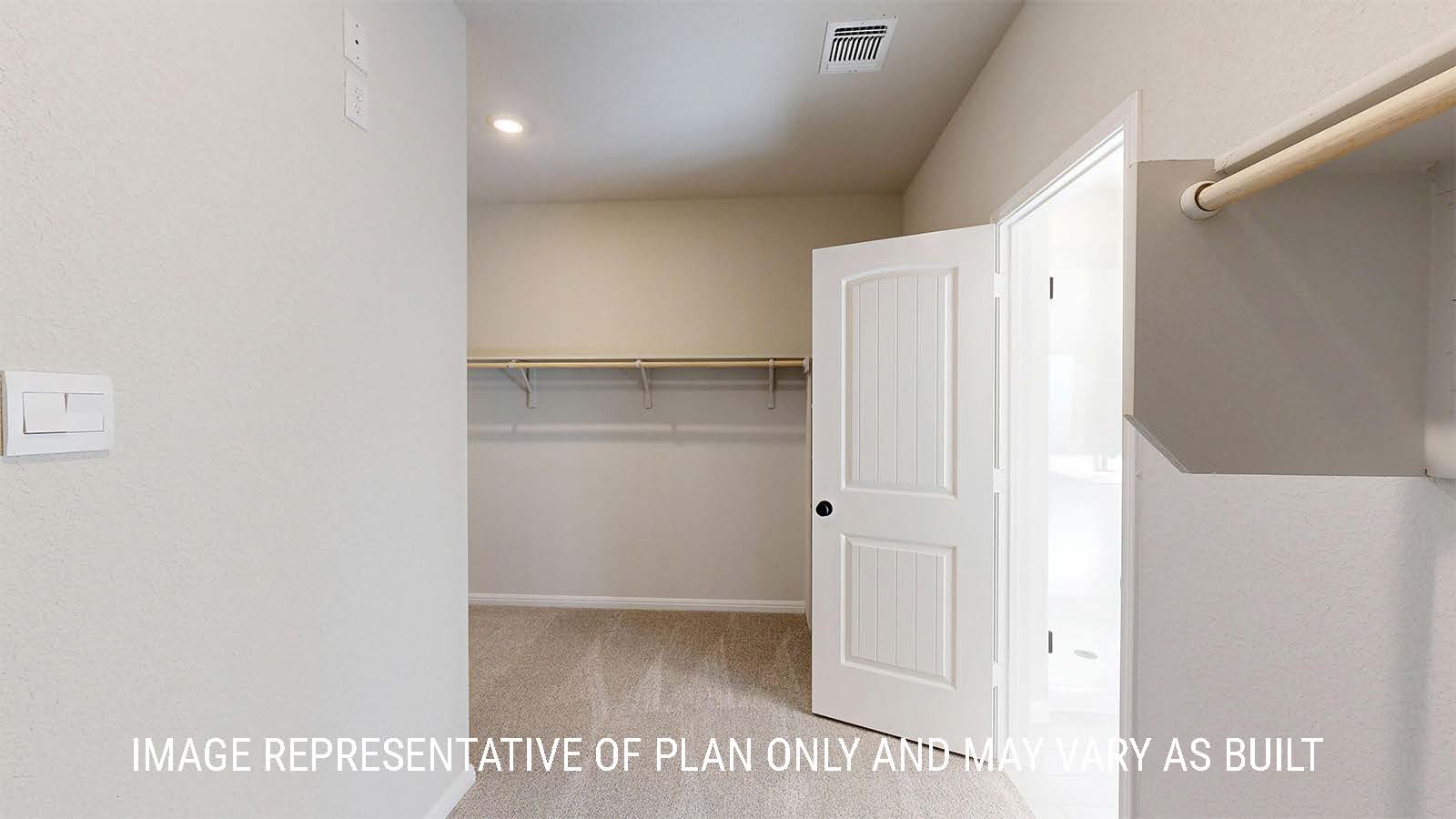 parker II primary closet with carpeted flooring and shelving for storage.
