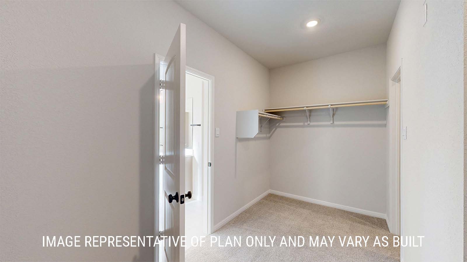 parker II primary closet with carpeted flooring and shelving for storage.