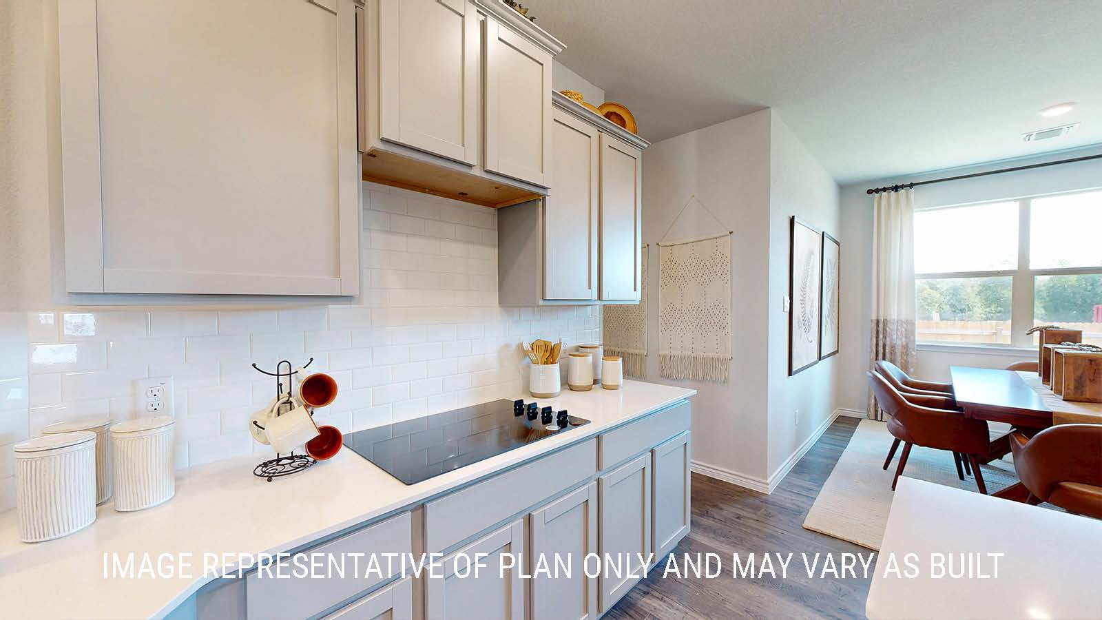 Newburgh kitchen with light cabinets and granite countertops with view of dining room.