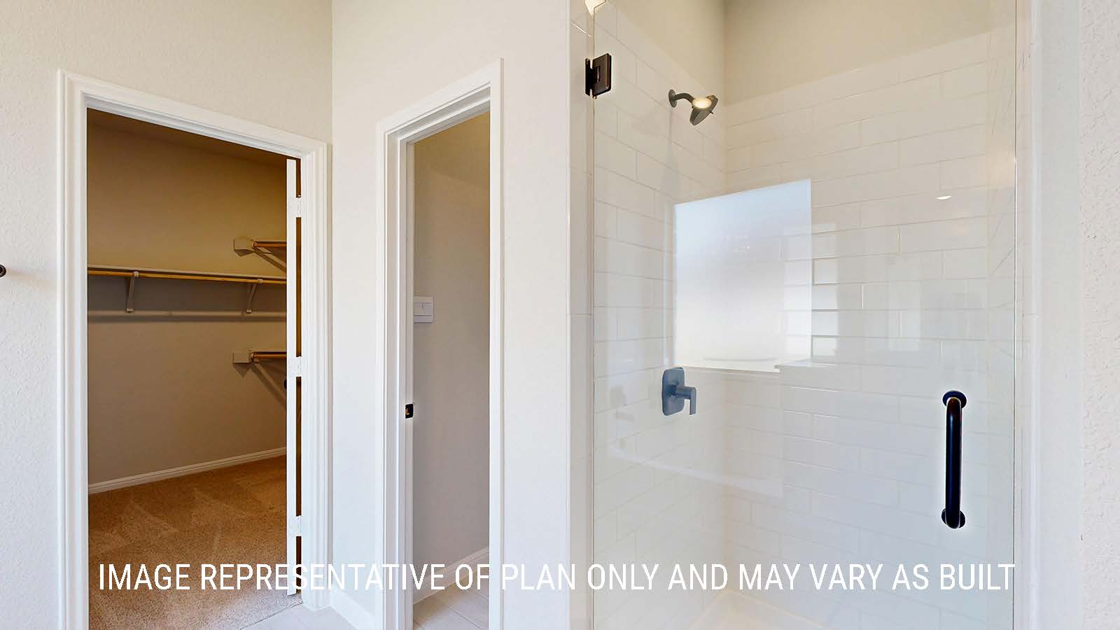 Waverley primary bathroom with walk-in shower and view of primary walk-in closet.