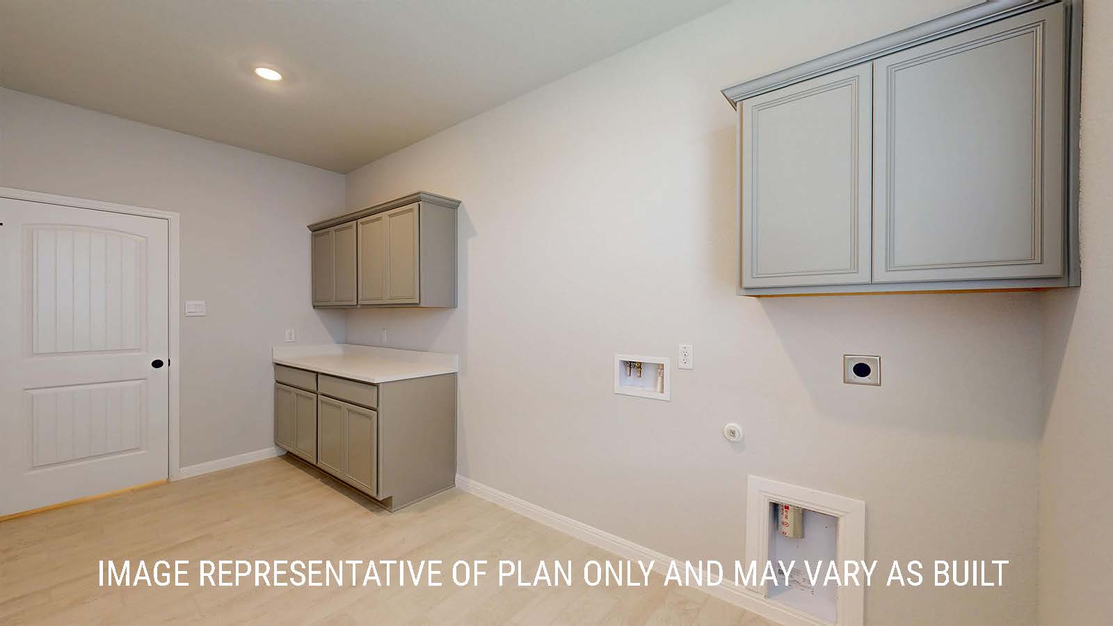 Waverley utility room with washer and dryer connections and cabinets for storage.