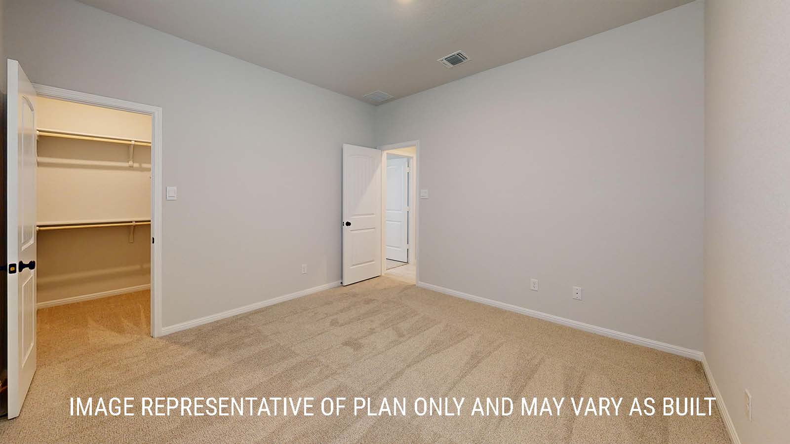 Waverley secondary bedroom with carpeted flooring and view of closet with shelving for storage.