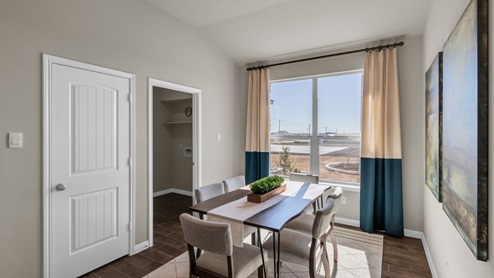 Sterling Meadows model home dining room with a view into the utility room.