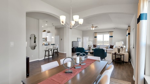 Sterling Meadows model home dining room with a view of the living room.