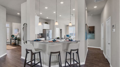 Sterling Meadows model home kitchen bar with granite countertops.