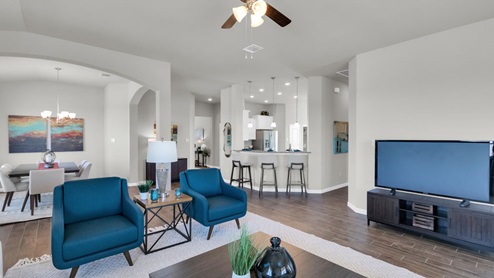 Sterling Meadows model home living room with view of kitchen.