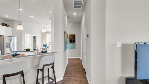 Sterling Meadows model home living room with view of hallway entry.