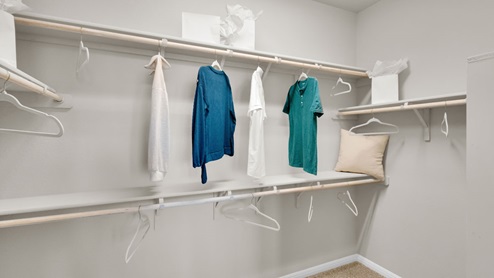 Sterling Meadows model home primary closet with spacious room.
