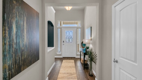 Sterling Meadows model home hallway entry with view of the front door.