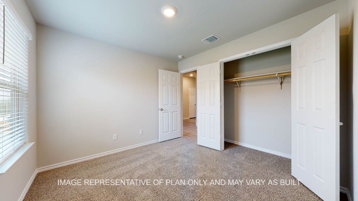 Elmwood secondary bedroom with carpet flooring and closet.