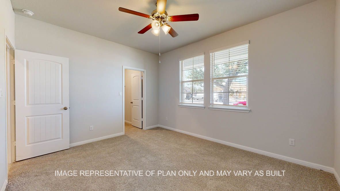 Parker secondary bedroom with carpet flooring and windows.