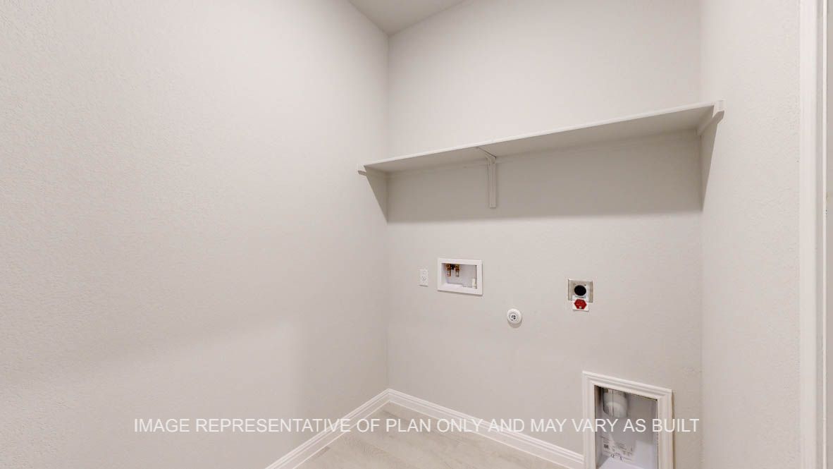 Parker utility room with wood look tile flooring and storage shelf.