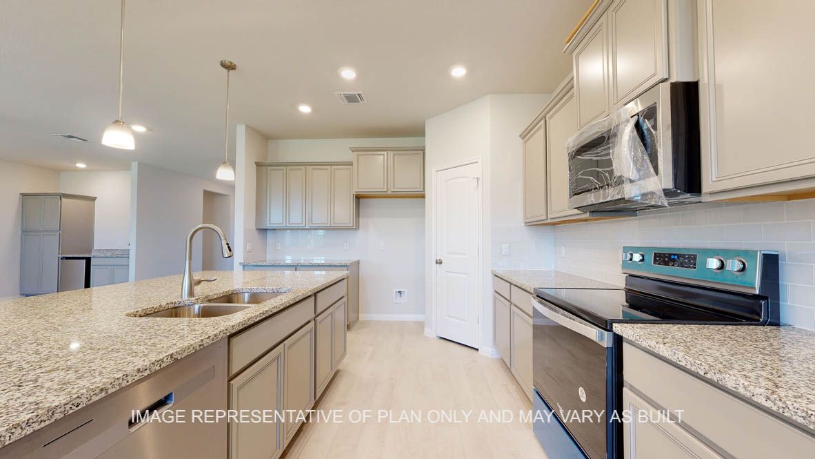 Parker kitchen with light griege painted cabinets, granite countertops and glass subway backsplash.