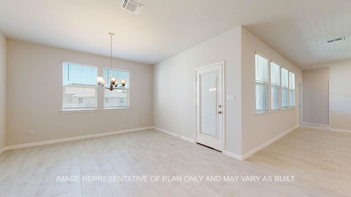 Parker dining with ample windows for natural lighting and wood look tile flooring.