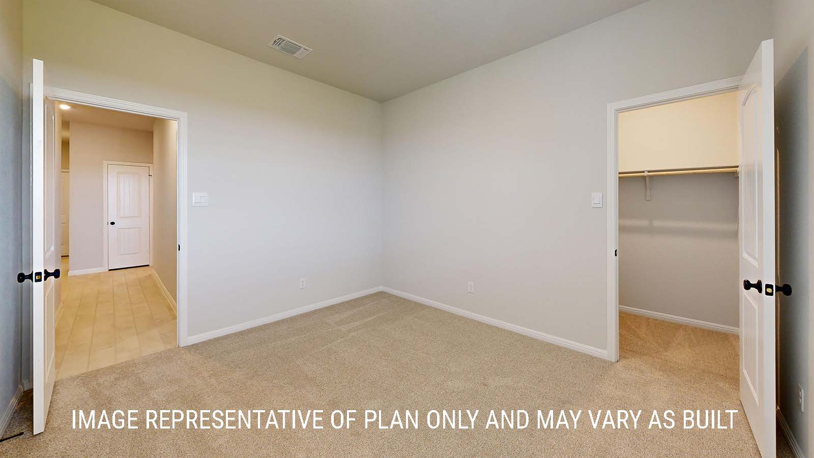 Waverley secondary bedroom with carpeted flooring and view of closet with shelving for storage.