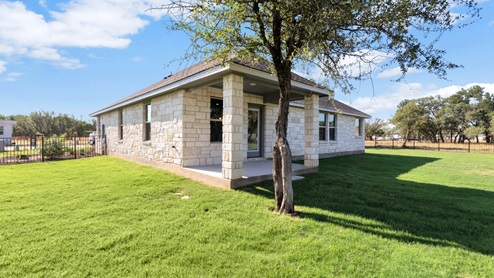 Delaware Springs model home backyard with a gated fence.