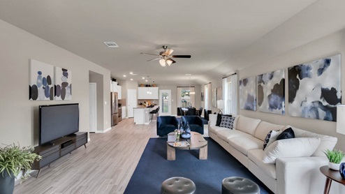 Delaware Springs model home living room open concept of the dining room and kitchen.