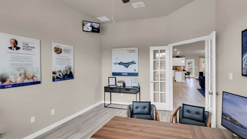 Delaware Springs model home secondary room with view of the living room and kitchen.