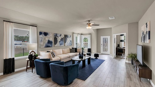 Delaware Springs model home living room with view of secondary bedroom.