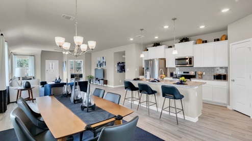 Delaware Springs model home dining room open concept of living room and kitchen.