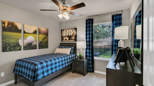 Delaware Springs model home secondary bedroom with a twin bed and accent decor.