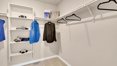 Delaware Springs model home primary closet with spacious room.
