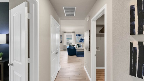 Delaware Springs model home hallway entry with view of utility room.