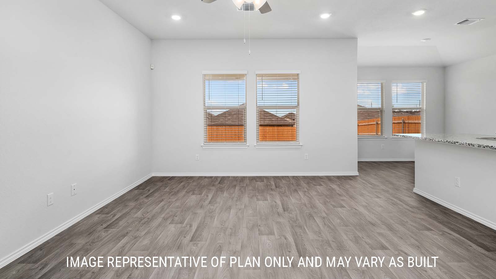 Ashburn living room with vinyl plank flooring and windows.