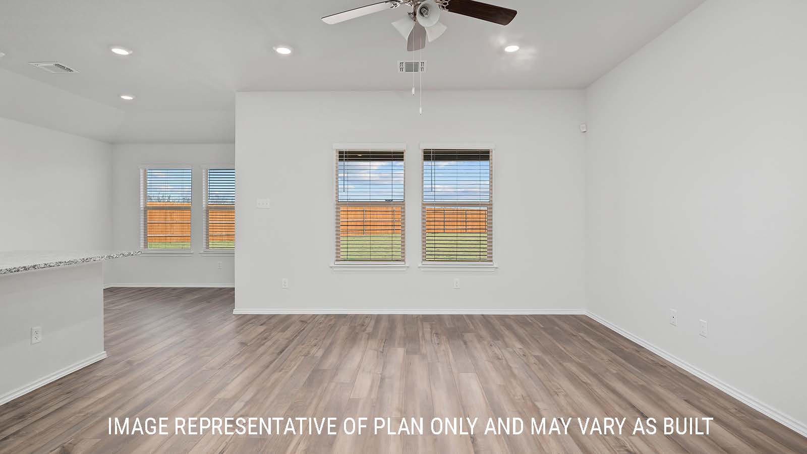 Bellvue living room with vinyl plank flooring and windows.