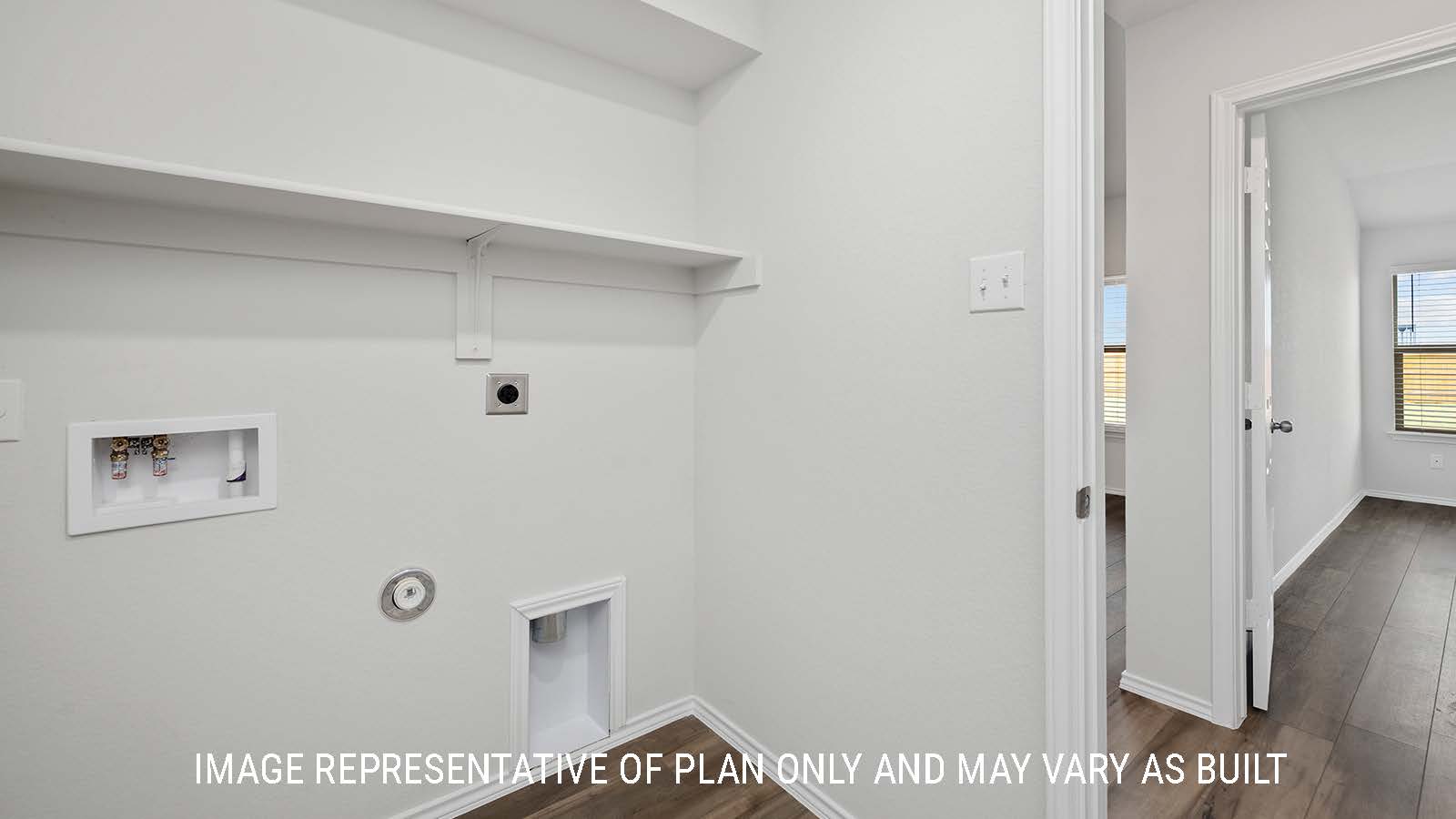 Bellvue utility room with shelving and washer and dryer connections.
