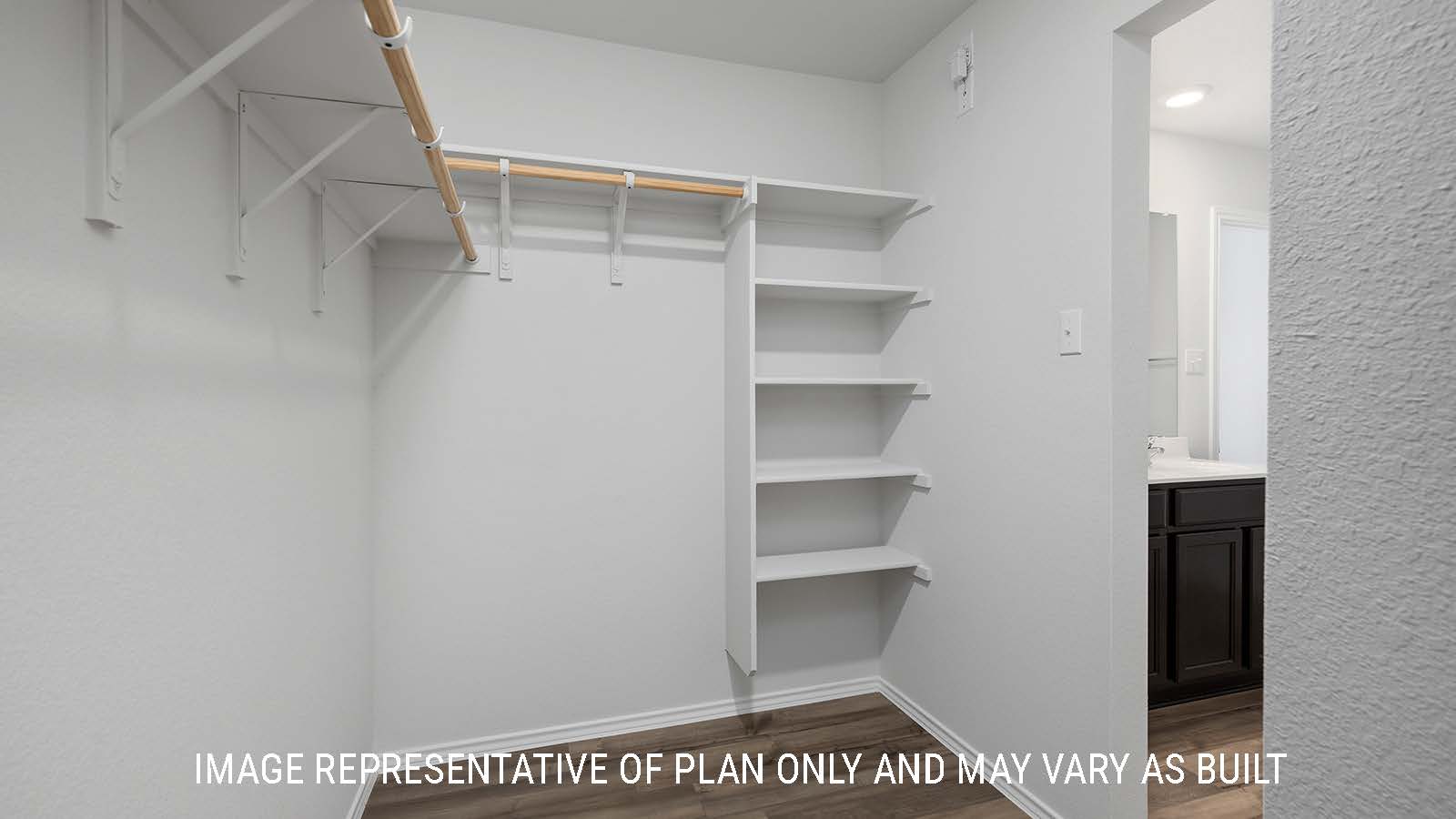 Bellvue primary closet with sleving and view of the primary bathroom.