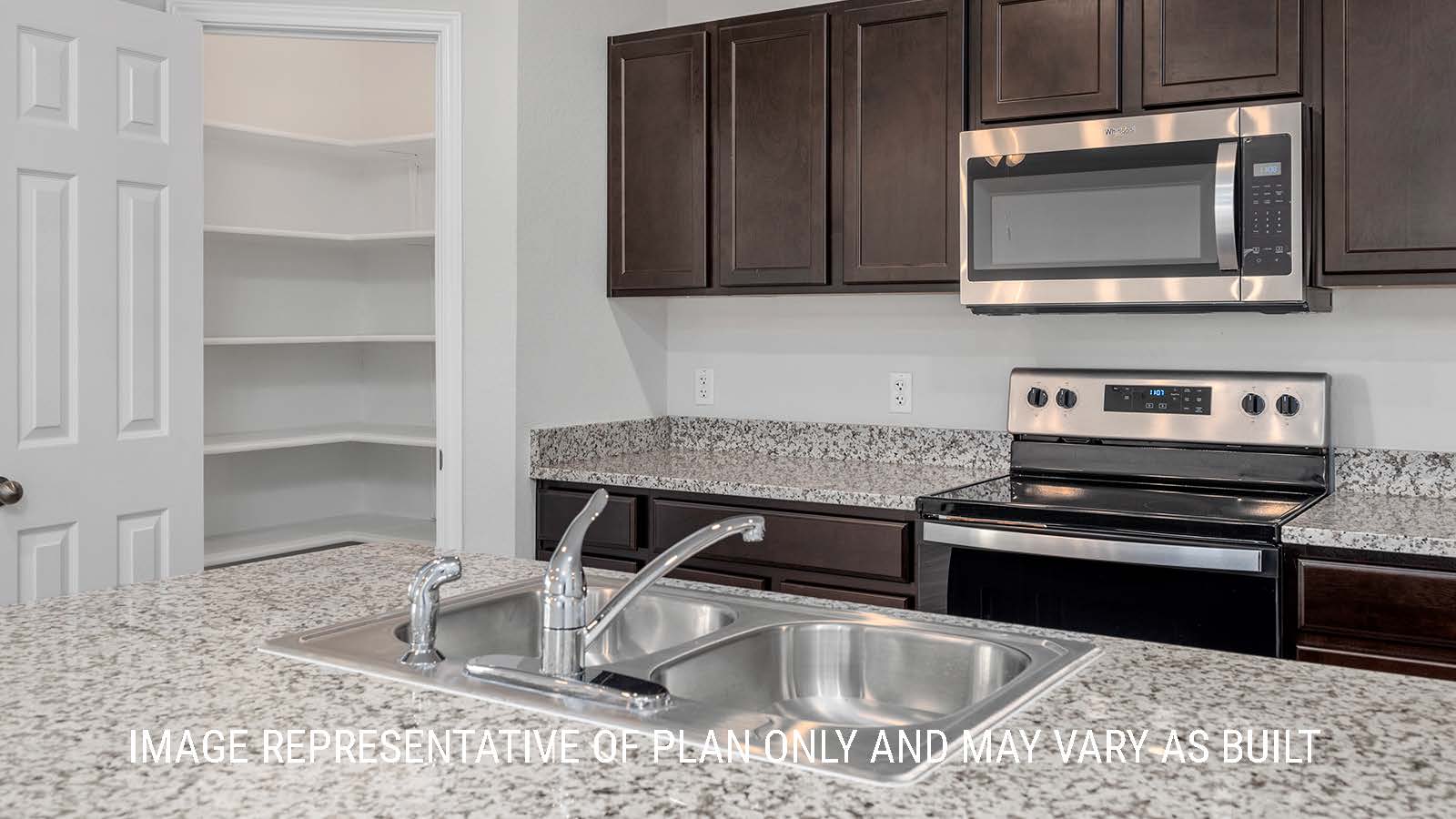 Camden kitchen with granite countertops and dark cabinets.