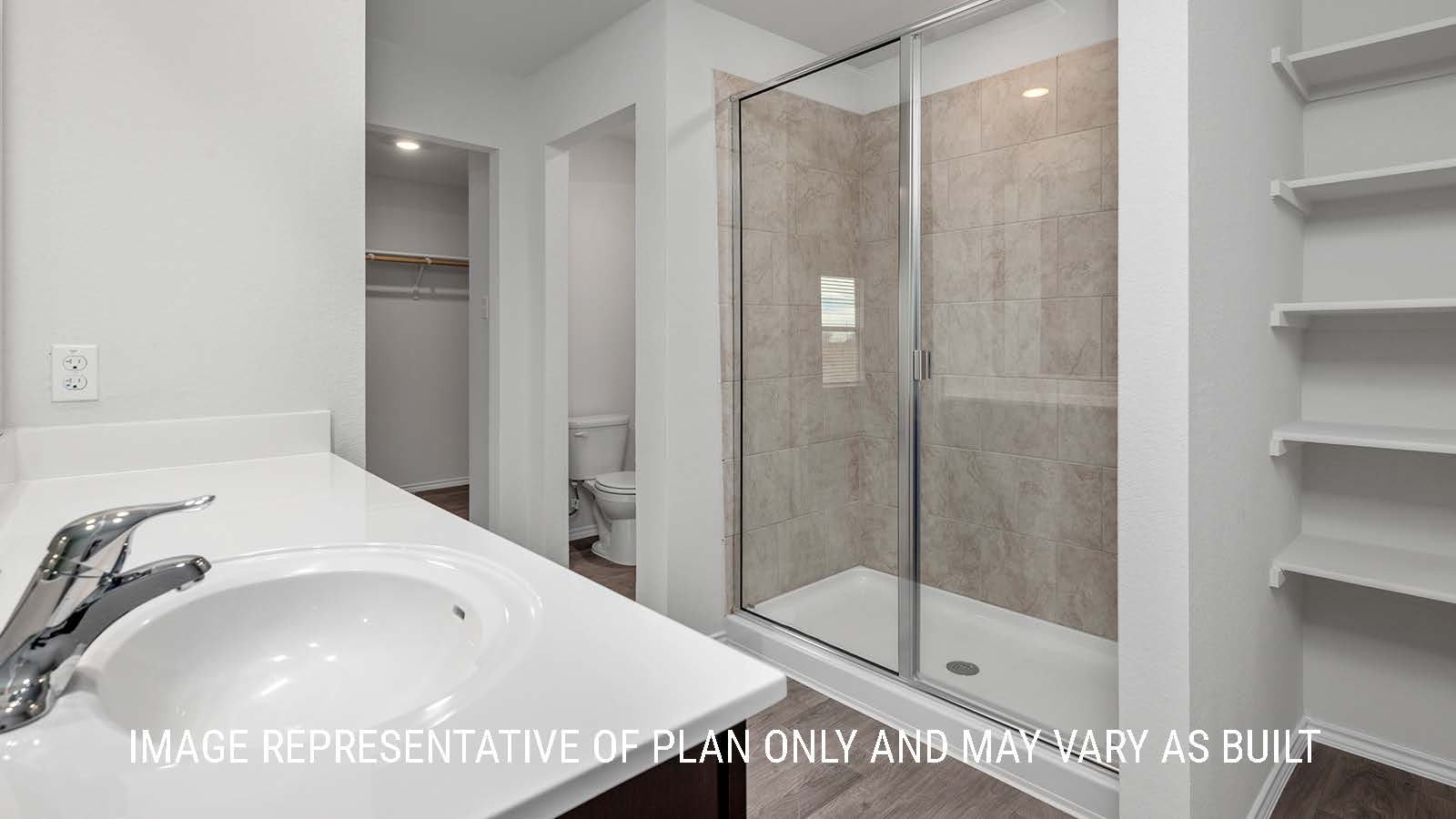 Camden primary bathroom with single vanity and view of the primary closet.