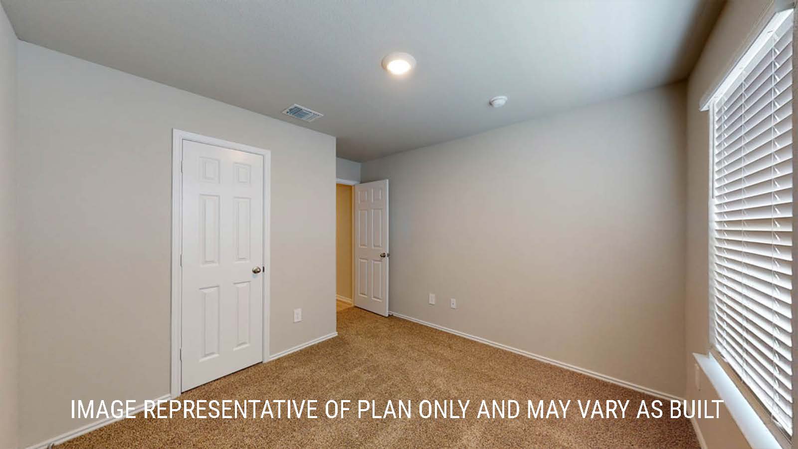 Camden secondary bedroom with closet and carpeted flooring.