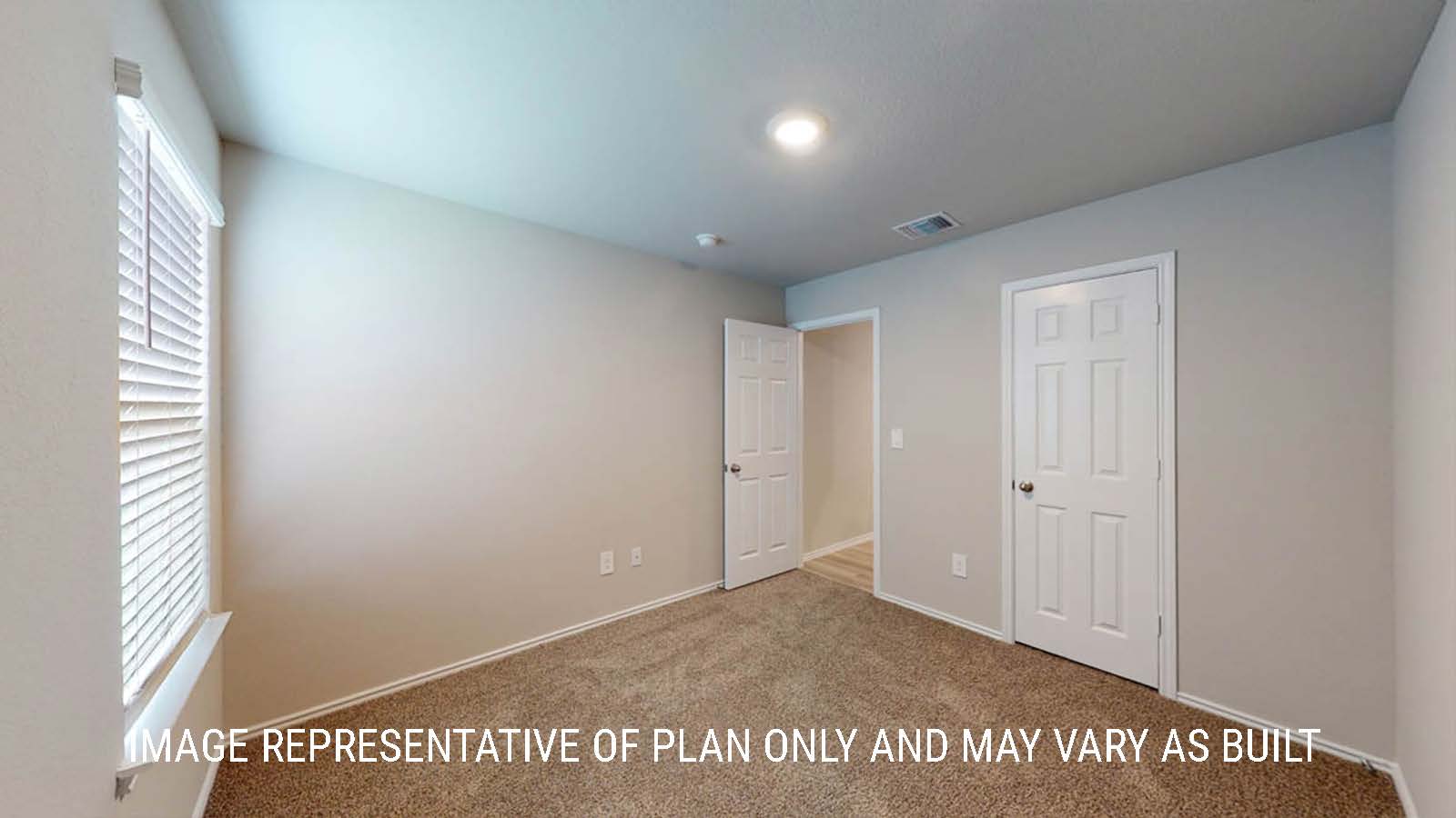 Camden secondary bedroom with closet and carpeted flooring.