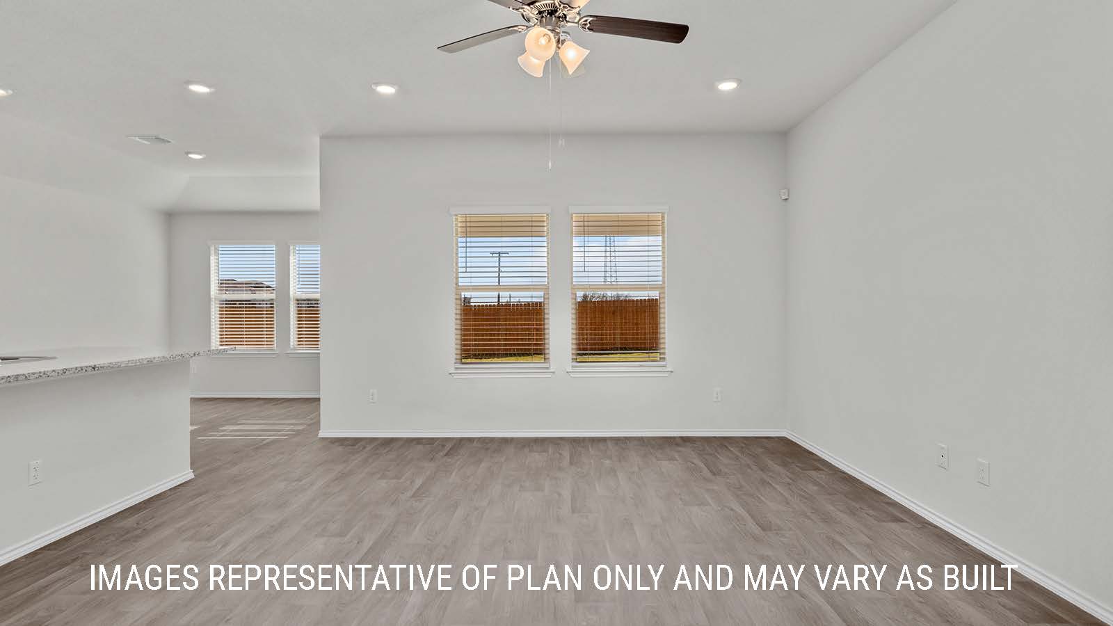 Fargo living room with vinyl plank flooring and view of the backyard.