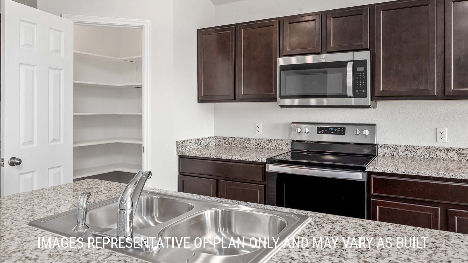 Fargo kitchen with granite countertops and dark cabinets.