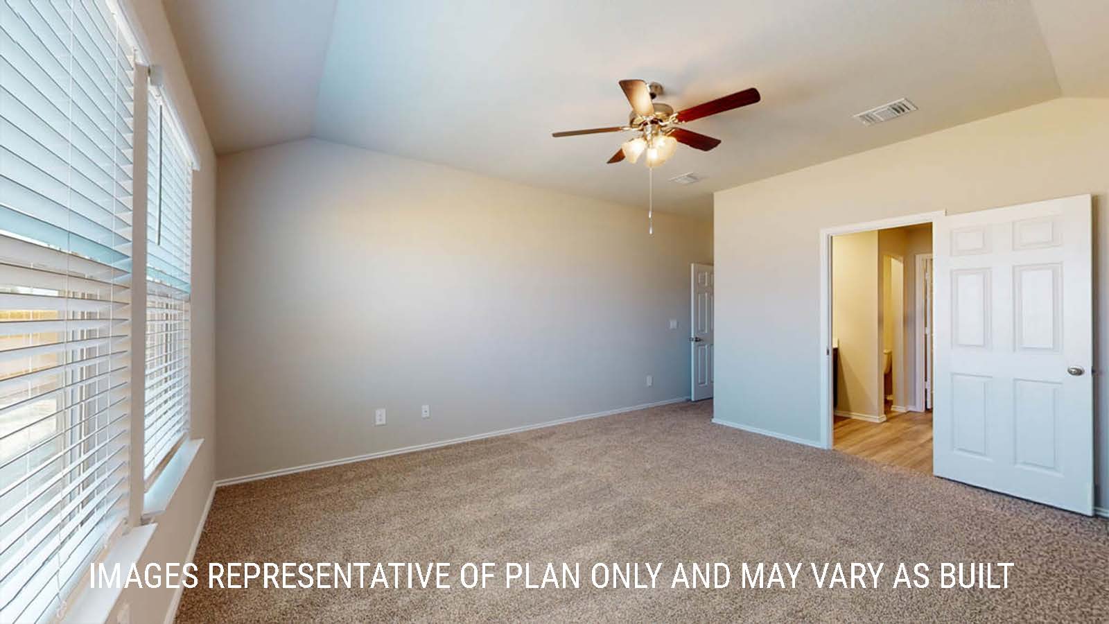 Fargo primary bedroom with carpeted flooring with view of primary bathroom.