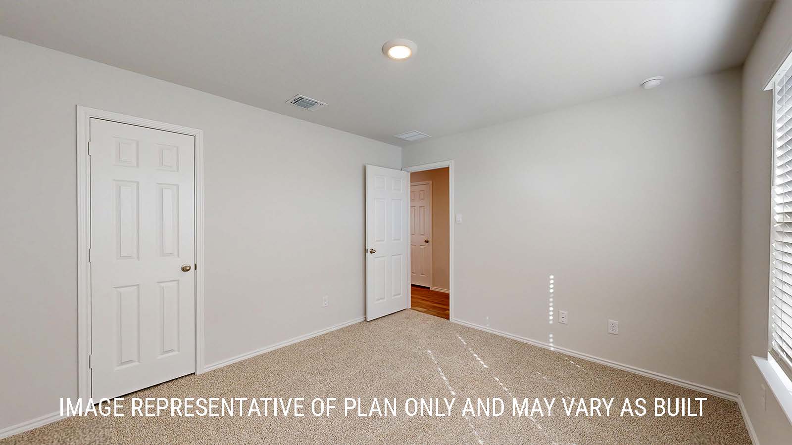 Seabrook secondary bedroom with carpeted flooring and window for lighting.