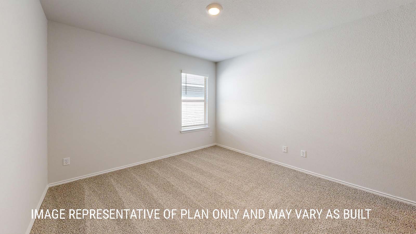 Seabrook secondary bedroom with carpeted flooring and window for lighting.