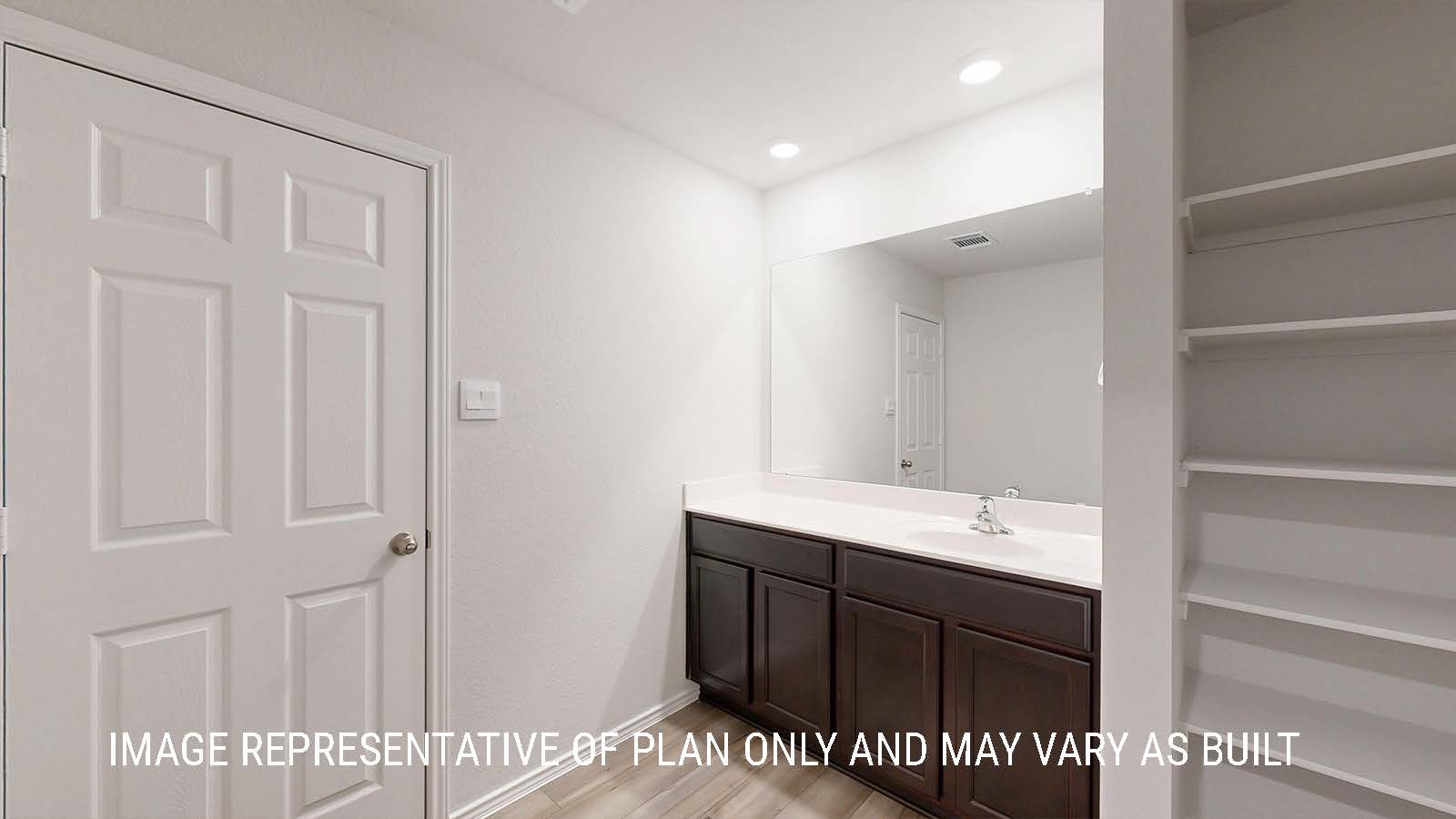 Seabrook primary bathroom with view of single vanity sink and shelving for storage.