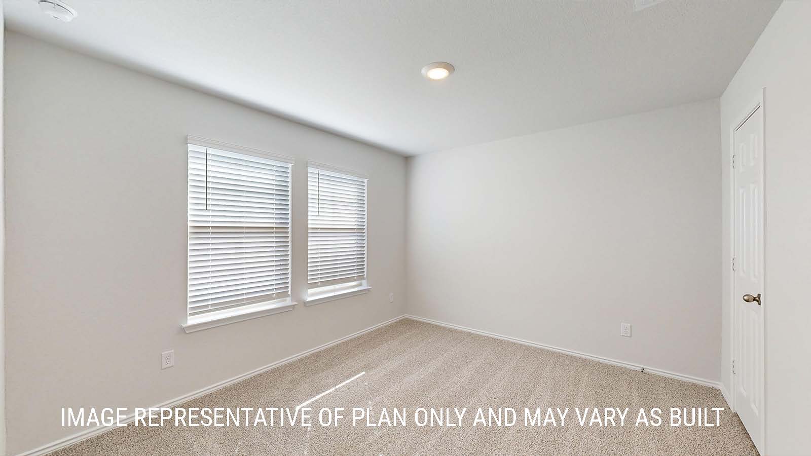 Seabrook secondary bedroom with carpeted flooring and window for lighting.