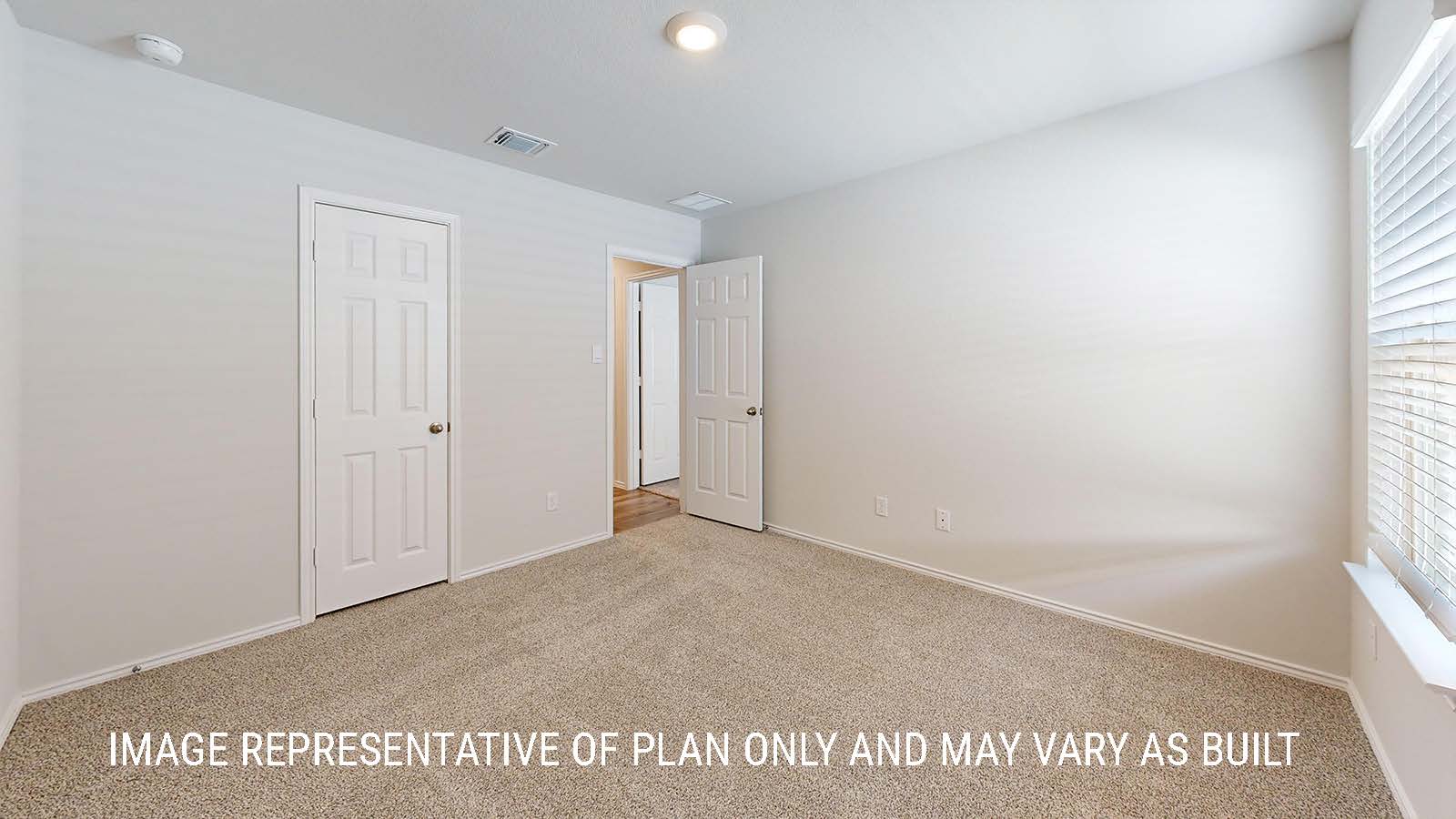 Seabrook secondary bedroom with carpeted flooring and window for lighting.