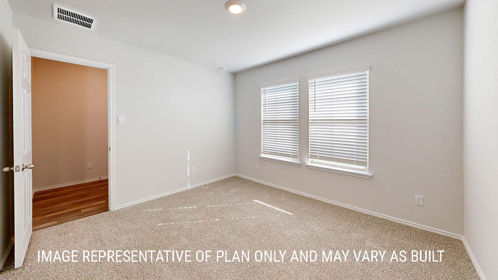 Seabrook secondary bedroom with carpeted flooring and window for lighting.