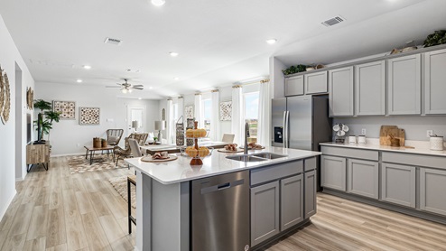 Mitchell Farm model home kitchen with open concept of the dining and living room.