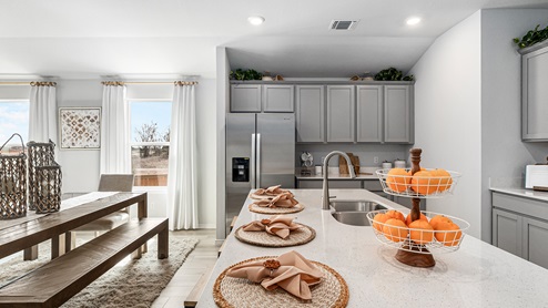 Mitchell Farm model home kitchen with a view of the dining room.