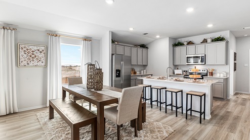 Mitchell Farm model home dining room with view of the kitchen.